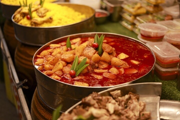 Traditional Thai Massaman curry chicken with potato in big pot at street food market stall offering authentic taste and delicious spicy flavor of local Asian cuisine for hungry tourist dinner meal
