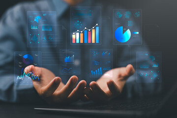 Businessperson holding analysis reports with charts and graphs, representing digital document automation and an integrated content management platform for business insights and reporting.