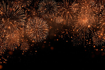 a bright display of copper colored fireworks exploding in the dark night sky