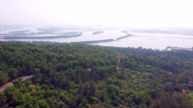 Aerial view of prawn farming ponds along the coastline, showcasing aquaculture and sustainable food production in Karnataka.