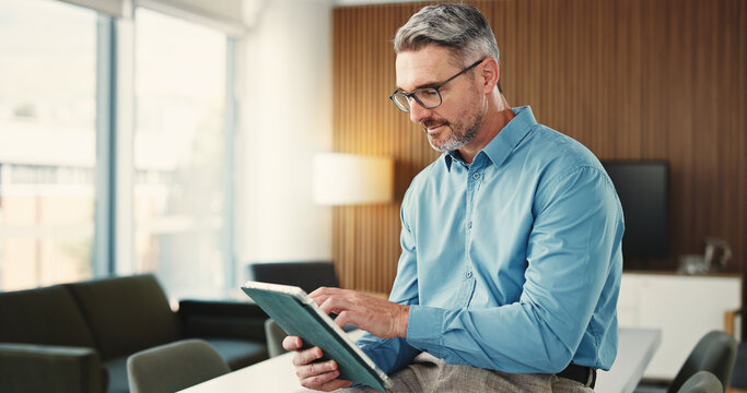 Business, tablet and mature man in office for finance review, investment and trading analyst. Professional, financial advisor and person on digital tech for stock market trends, research and profit
