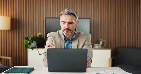 Man, reading and employee with laptop, office and research for risk assessment on website and...