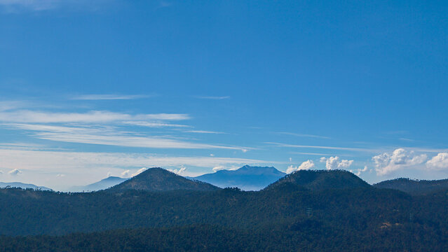 Minimal panoramic view of mountain silhouettes under a clear blue sky in Ajusco near Mexico City. Calm natural landscape with layered hills and wide copy space, perfect for travel, freedom and outdoor