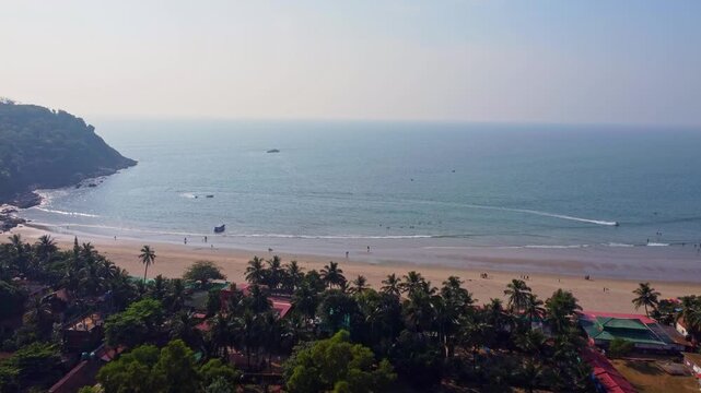 Aerial view of Kudle Beach in Gokarna, Karnataka, showing the sandy shoreline, palm trees, and calm Arabian Sea.