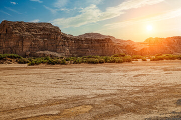 Desert sandy ground and spectacular yardang landform mountain natural landscape at sunset