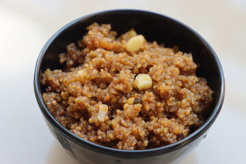 Laapsi or lapsi, Indian sweet made using broken wheat grains and ghee, along with milk, nuts,...