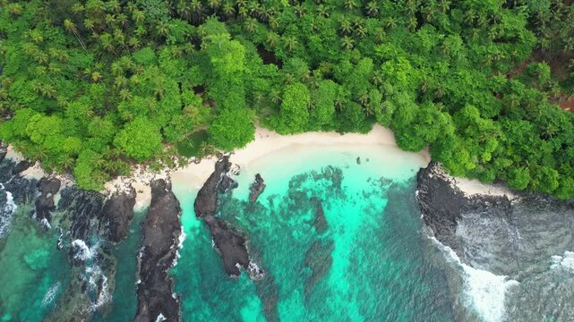 Aerial descending view over Cafe beach and its turquoise sea at Ilheu das Rolas,S&atilde;o Tom&eacute;,Africa