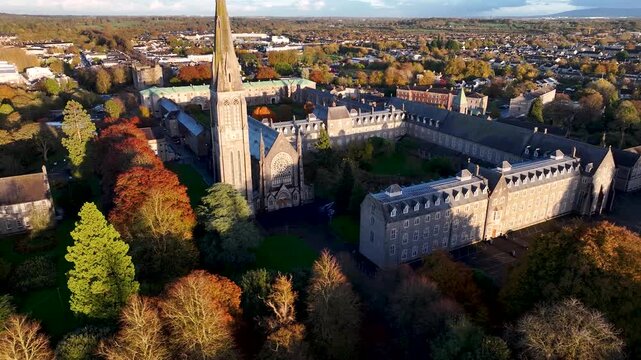 Old college building and chapel tower in Maynooth University, Kildare, Ireland. Beautiful Autumn day.
