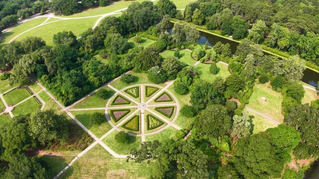 Drone footage shows a circular garden with a radial star design and cross-shaped paths surrounded by lawns and trees at Middleton Place Plantation in Charleston, South Carolina
