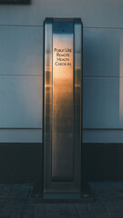 Public healthcare access kiosk glowing in evening sun, public health check station for equity and wellness support in urban street setting offering remote health checkin service