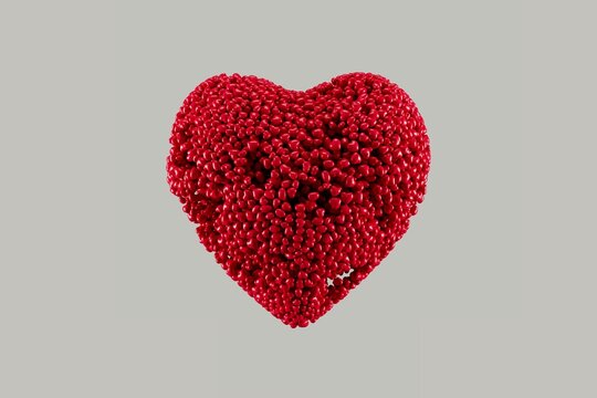 Romantic background featuring a heart shape formed by thousands of small glossy red hearts on a neutral backdrop. Clean symbolic composition suitable for love concepts, Valentine&rsquo;s Day designs and emo