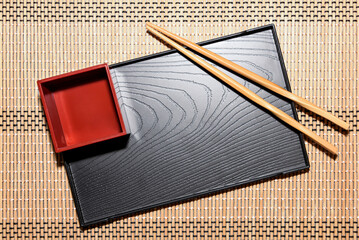 Gyoza or sushi tray with sauce container and chopsticks