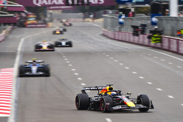 Naklejka premium BAKU, AZERBAIJAN - SEPTEMBER 21, 2025: Sergio Perez in the Oracle Red Bull Racing RB21 leads a pack of Formula 1 cars down a straight at the Baku City Circuit during the Azerbaijan Grand Prix