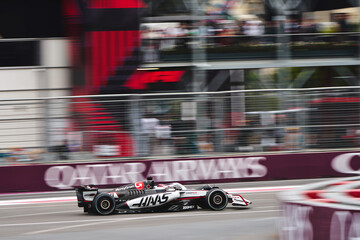 Naklejka premium BAKU, AZERBAIJAN - SEPTEMBER 21, 2025: Esteban Ocon speeds along the Baku City Circuit in his MoneyGram Haas F1 Team car during the Formula 1 Azerbaijan Grand Prix