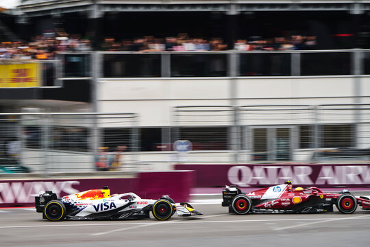 BAKU, AZERBAIJAN - SEPTEMBER 21, 2025: Liam Lawson in the Visa Cash App RB leads Lewis Hamilton's Ferrari SF-25 through the streets of Baku during the Formula 1 Azerbaijan Grand Prix
