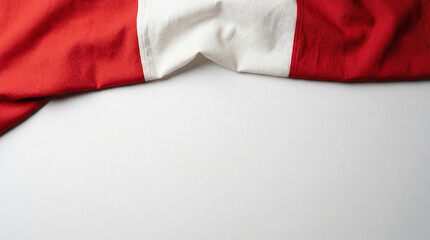 Obraz premium Close-up of red and white fabric draped on a plain background, ideal for textile design and fabric showcases.