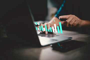 Person working on laptop with digital business growth chart overlay