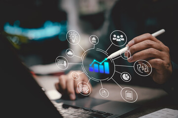 Business analyst using digital pen with virtual graph and data analytics interface over laptop