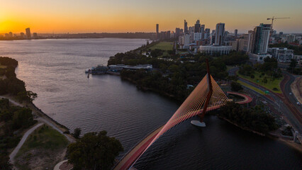 Obraz premium Aerial view of Perth city skyline with Boorloo bridge lit up connecting Heirisson island with walking and cycling path along the Swan river