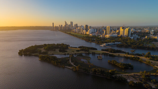Aerial view of Perth city skyline with Boorloo bridge lit up connecting Heirisson island with walking and cycling path along the Swan river