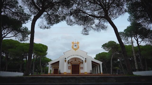 Religious concept. Top of a small church. The cross stands out against the sunset. Super slow motion. 100 fps