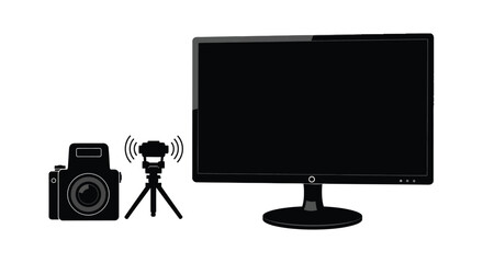 a digital camera wireless transmitter and a black computer monitor display a dark silhouette