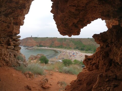 Bolata Beach viewed through a heart-shaped sea cave on Bulgaria&rsquo;s northern Black Sea coast, featuring red cliffs, a protected bay near Kaliakra, and unique natural scenery, 2021