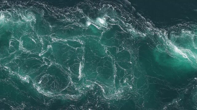 Powerful Turquoise Currents Churn and Twist in Dramatic Whirlpools at Saltstraumen, Norway - High Angle Shot