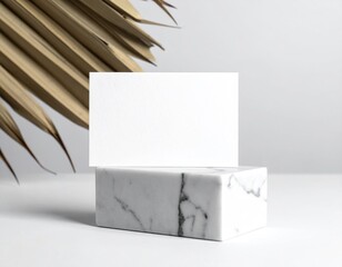 Blank card on marble with dry leaf