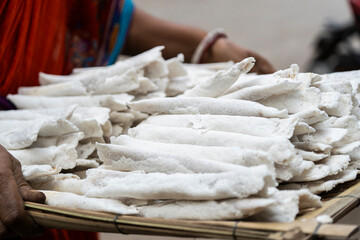 Vendor display Assamese traditional pitha, rice based snacks food items during Magh Bihu.