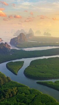 Scenic of Phang Nga bay with mountains at sunset in Thailand. Vertical.