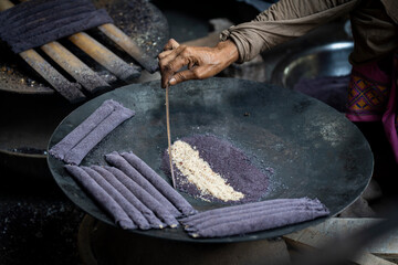 Women prepare 'Pitha', Assamese traditional rice-based sweets or snacks,  on the 'Magh Bihu' festival
