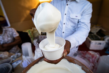 Vendor selling cream dairy product  at a stall during magh Bihu