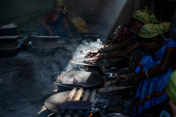 Women prepare 'Pitha', Assamese traditional rice-based sweets or snacks,  on the 'Magh Bihu' festival