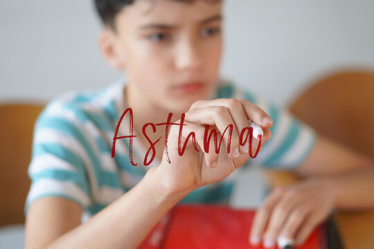 ASTHMA. Health and well-being in childhood and adolescence. Preteen child writing text on the screen with a red marker.
