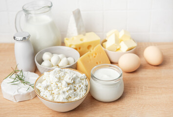 Assorted dairy products and fresh eggs on wooden background