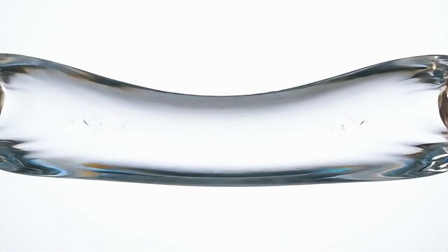 Abstract close-up macro photography of a clear liquid wave distorted by gravity and surface tension on a white background