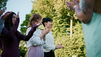 Fototapeta premium The groom walks past the applauding guests at an outdoor wedding