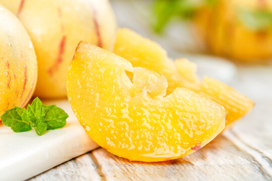 Fresh Yellow Peaches with Sweet Flesh and Mint Garnish