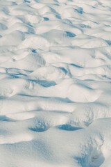 Wind-sculpted snow surface with ripples and shadows texture