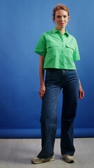 Young woman posing in studio, full growth video, vertical video