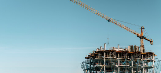 Construction of a building banner background. Construction site with crane. Business, development, industry.