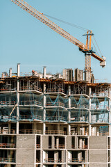 Construction of a building. Construction site with crane. Business, development, industry.