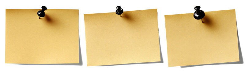 three yellow sticky notes with black push pins
