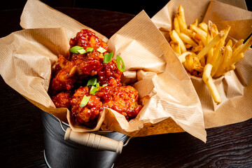 Delicious spicy chicken wings served with crispy fries create a perfect meal moment