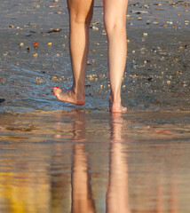 A woman's feet are in the water