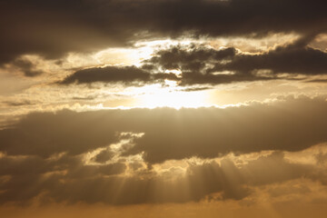 The sun is shining through the clouds