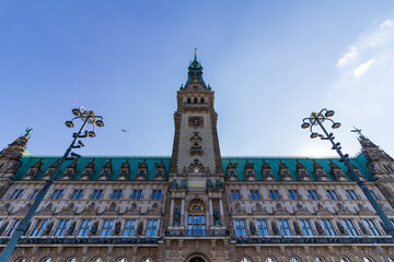 Low angle view of the historic Hamburg City Hall (Rathaus) tower and facade with ornate lamp posts