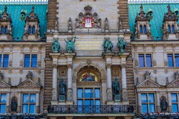 Close-up detail of Hamburg City Hall (Rathaus) facade with statues, coat of arms and Latin inscription