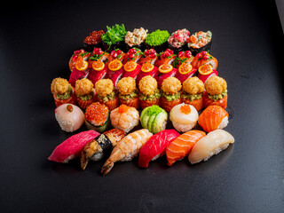 A stunning array of sushi pieces arranged beautifully on a dark surface, inviting a taste adventure